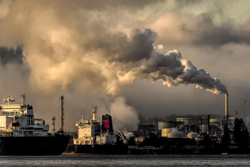 Industrial plant with emissions stacks at dusk